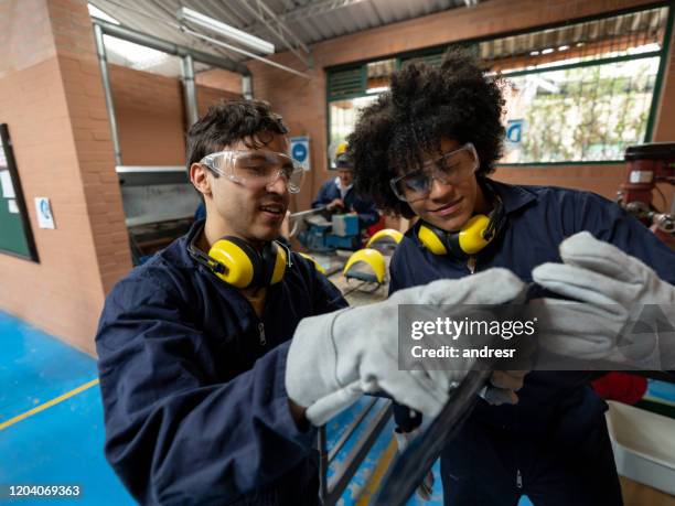 engineering students working on a project at the workshop - apprentice builder stock pictures, royalty-free photos & images