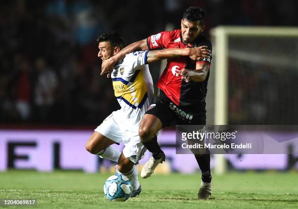 Eduardo Salvio of Boca Juniors fights for the ball with Rafael Delgado of Colon during a match between Colon and Boca Juniors as part of Superliga...