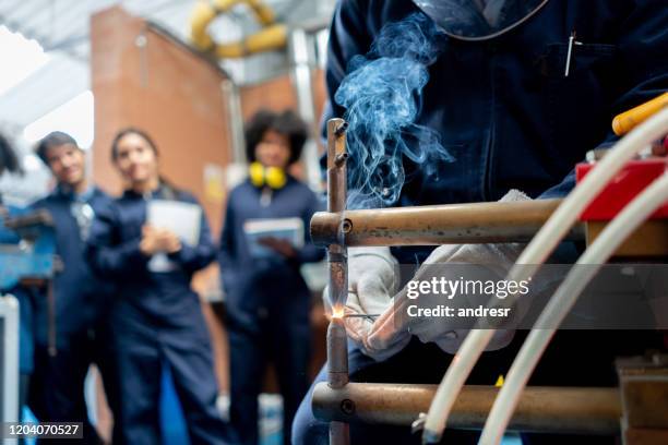 group of students learning how to weld - student welder stock pictures, royalty-free photos & images