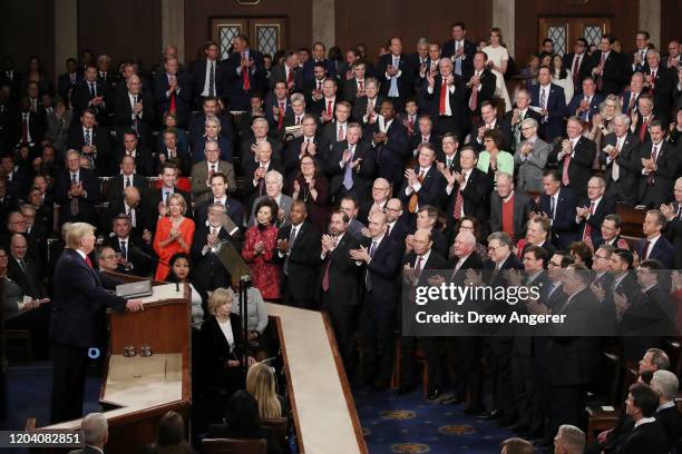 Members of Congress applaud as President Donald Trump delivers the State of the Union address House Speaker Rep. Nancy Pelosi and Vice President Mike...