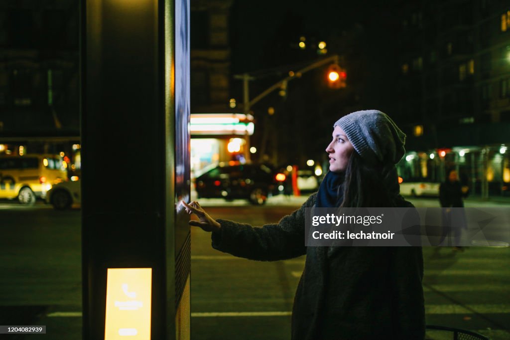 Woman using touch screen city display