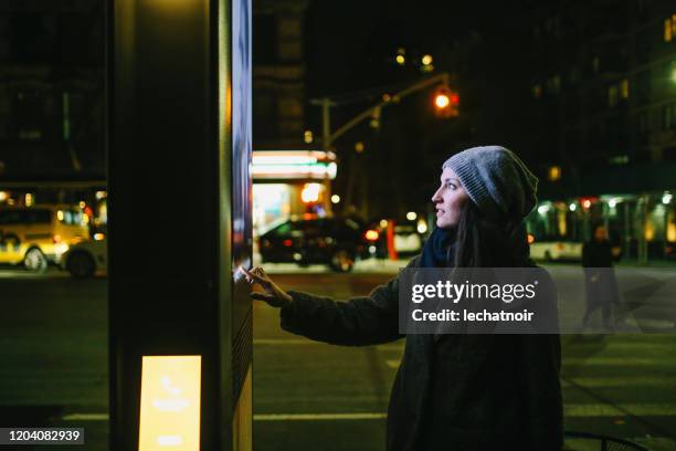 woman using touch screen city display - looking outside stock pictures, royalty-free photos & images