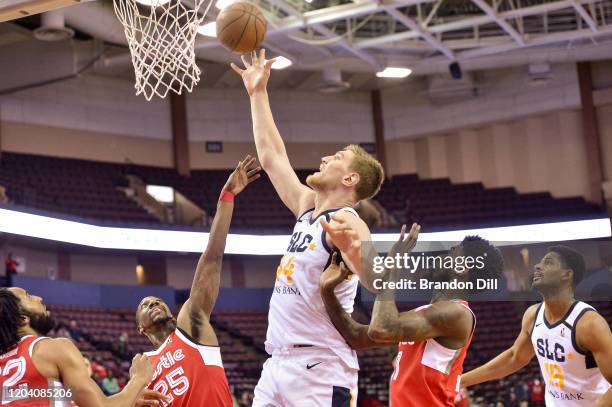 Isaac Haas of the Salt Lake City Stars shoots between Marquis Teague and Shaq Buchanan of the Memphis Hustle in an NBA G-League game on February 28,...