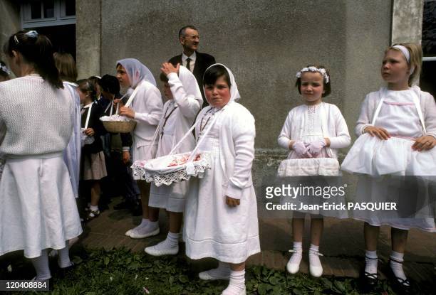 God Festival In France In 1987 - Girls in their Sunday best participant in the procession of Corpus Christi-The baskets are filled with rose petals...