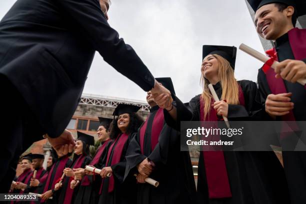 student handshaking with the headmaster on her graduation day - dean stock pictures, royalty-free photos & images