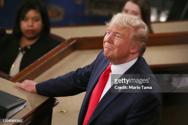 President Donald Trump delivers the State of the Union address House Speaker Rep. Nancy Pelosi and Vice President Mike Pence look on in the chamber...