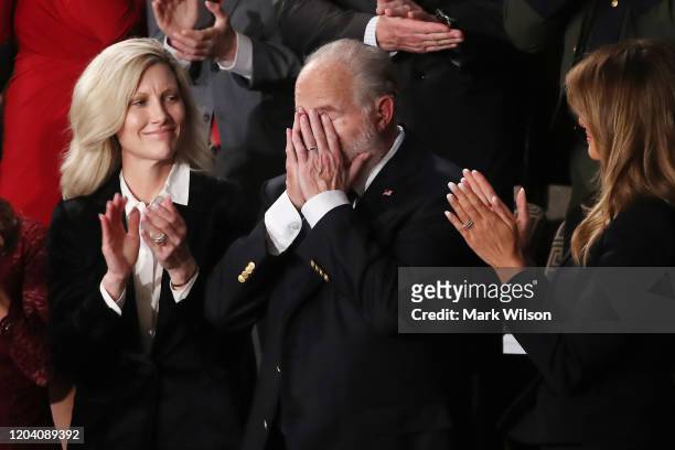 Radio personality Rush Limbaugh reacts during the State of the Union address as First Lady Melania Trump and his wife Kathryn look on in the chamber...