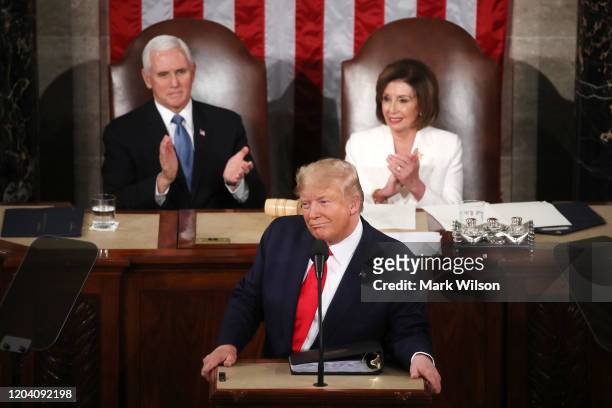 President Donald Trump delivers the State of the Union address as House Speaker Rep. Nancy Pelosi and Vice President Mike Pence look on in the...