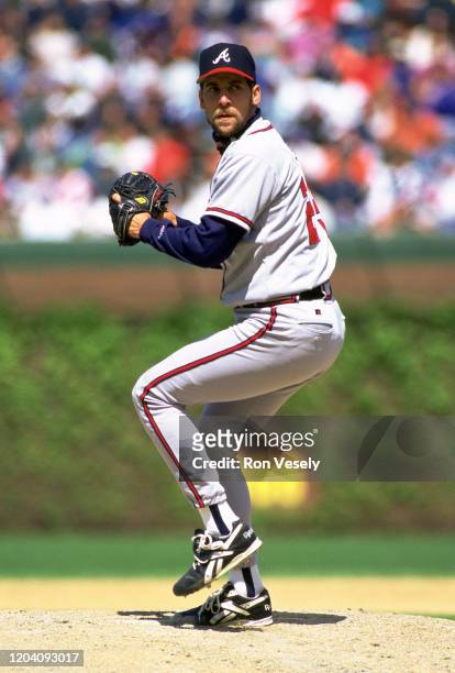 John Smoltz of the Atlanta Braves pitches during an MLB game at Wrigley Field in Chicago, Illinois. Smoltz played for 21 seasons with 3 different...