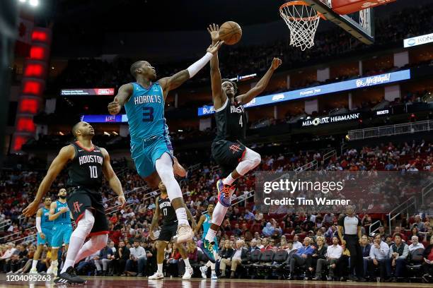 Terry Rozier of the Charlotte Hornets shoots the ball while defended by Danuel House Jr. #4 of the Houston Rockets in the second half at Toyota...