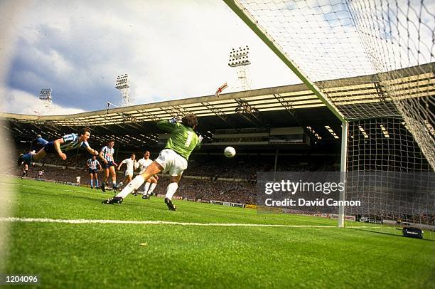 Keith Houchen of Coventry City scores a dramatic diving header during the 1987 FA Cup Final against Tottenham Hotspur played at Wembley Stadium in...