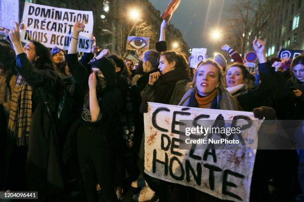 Feminist activists holding signs demonstrate outside the Salle Pleyel in Paris as guests arrive for the 45th edition of the Cesar Film Awards...