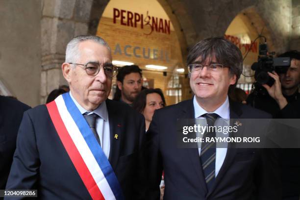 Perpignan mayor Jean-Marc Pujol and European Member of Parliament and former Catalan president Carles Puigdemont leave Perpignan's city hall on...