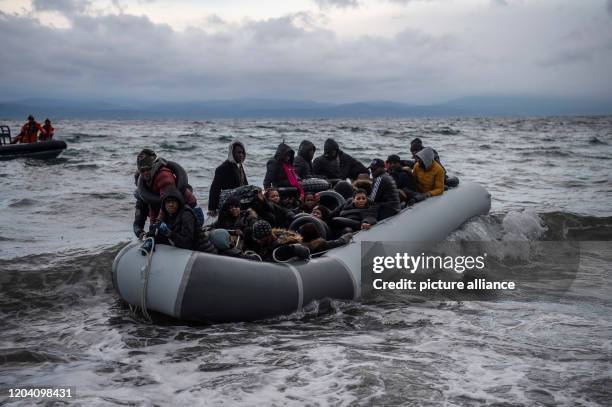 February 2020, Greece, Lesbos: Migrants from Africa arrive from Turkey in a rubber dinghy on the beach of the village of Skala Sikamias on Lesbos....