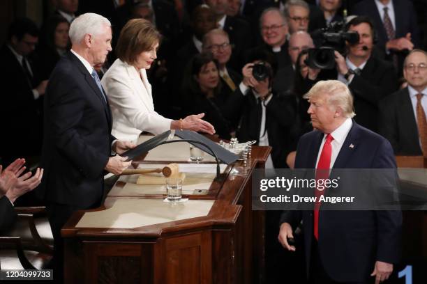 House Speaker Rep. Nancy Pelosi attempts to shake hands with President Donald Trump in the beginning of the State of the Union address as Vice...