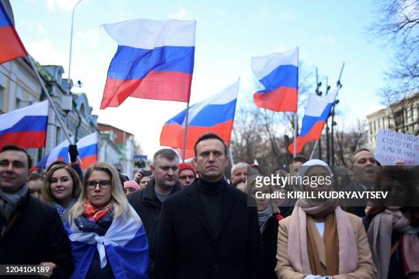 Russian opposition leader Alexei Navalny, his wife Yulia, opposition politician Lyubov Sobol and other demonstrators march in memory of murdered...