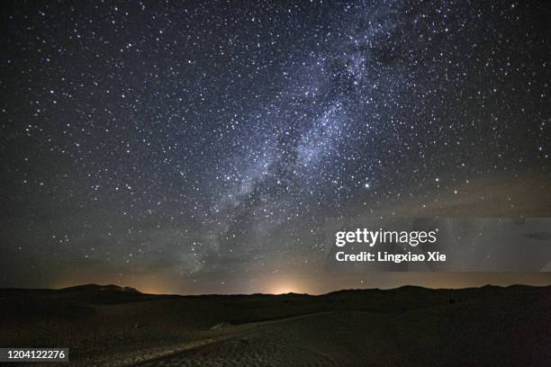 milky way and starry night shining above the famous sahara desert, morocco, africa - desert sky stock pictures, royalty-free photos & images