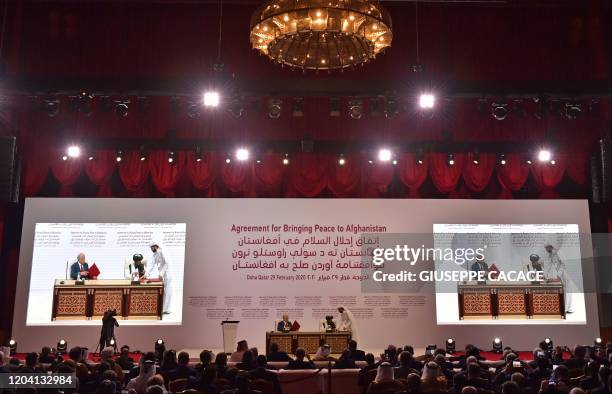 Special Representative for Afghanistan Reconciliation Zalmay Khalilzad and Taliban co-founder Mullah Abdul Ghani Baradar sign a peace agreement...