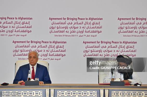 Special Representative for Afghanistan Reconciliation Zalmay Khalilzad and Taliban co-founder Mullah Abdul Ghani Baradar sign a peace agreement...