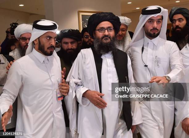 Taliban co-founder Mullah Abdul Ghani Baradar leaves after signing an agreement with the United States during a ceremony in the Qatari capital Doha...