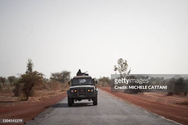 Troops of the Malian army patrol the road between Mopti and Djenne in central Mali on February 28, 2020. - A week earlier Mali's Prime Minister...
