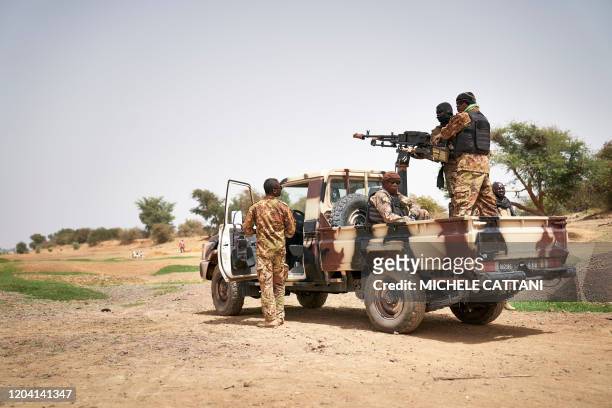 Malian army soldiers patrol the area next to the river of Djenne in central Mali on February 28, 2020. - A week earlier Mali's Prime Minister...