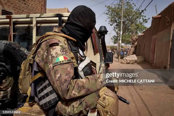 Soldier of the Malian army is seen during a patrol on the road between Mopti and Djenne, in central Mali, on February 28, 2020. A week earlier Mali's...