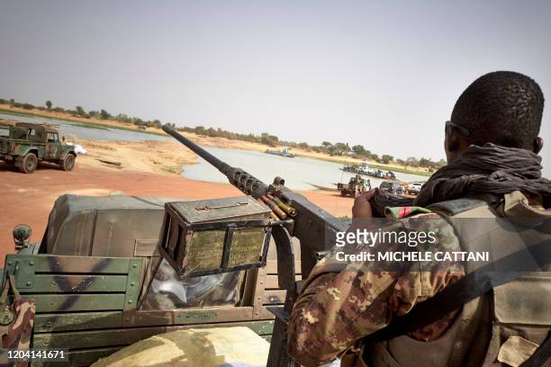 Soldier of the Malian army is seen during a patrol on the road between Mopti and Djenne, in central Mali, on February 28, 2020. - A week earlier...