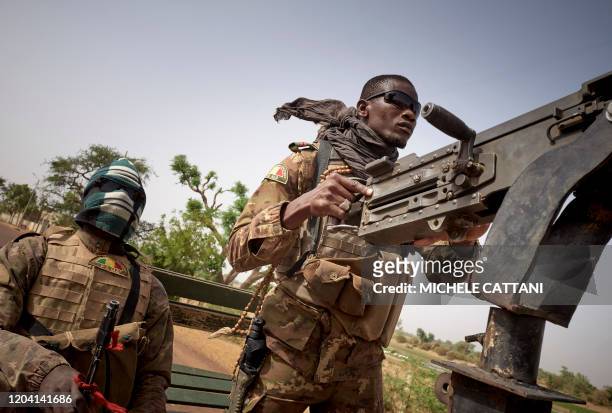 Soldiers of the Malian army are seen during a patrol on the road between Mopti and Djenne, in central Mali, on February 28, 2020. A week earlier...