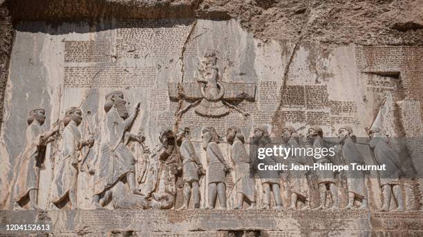 bisotun / behistun inscription, a rock relief and message from darius the great, engraved in cliff of zagros mountains, kermanshah province, iran - persian stock pictures, royalty-free photos & images