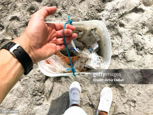 recycling and cleaning the beach of miami from plastic trash. - better world stockfoto's en -beelden