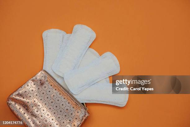 sanitary pad background in  orange background - sanitary napkins stock pictures, royalty-free photos & images