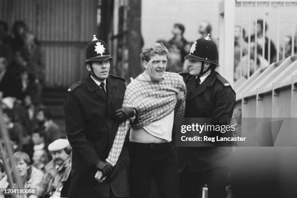 Police restraining a football fan at the FA Cup Fifth Round replay between Luton Town and Watford at Kenilworth Road in Luton, England, 9th March...