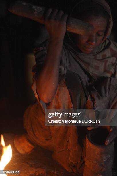 Woman grinding coffee for the traditional Ethiopian coffee ceremony, Simien in Ethiopia.