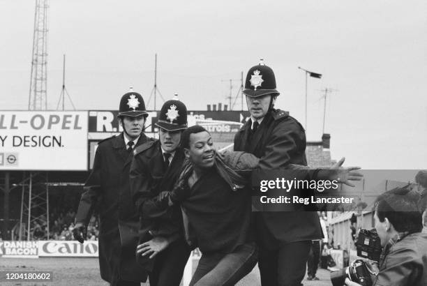 Police restraining a football fan at the FA Cup Fifth Round replay between Luton Town and Watford at Kenilworth Road in Luton, England, 9th March...