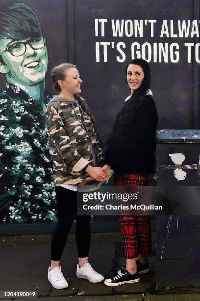 Robyn Peoples and Sharni Edwards, Northern Ireland's first same-sex couple to be legally married, pose in front of the Lyra McKee mural during a...