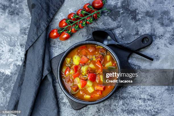 bowl of vegan potato goulash - soup vegtables stock-fotos und bilder