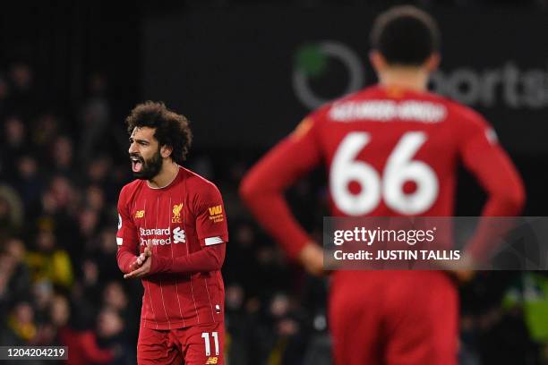 Liverpool's Egyptian midfielder Mohamed Salah reacts after Watford's Senegalese midfielder Ismaila Sarr scores his team's second goal during the...