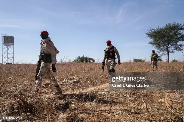 Maradi,Niger. December 12, 2019. Niger Army troops walk close to a water tower while on patrol near the Nigerian border in southern Niger.