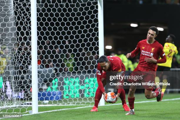 Dejected Virgil van Dijk of Liverpool collects the ball from the empty net after the 2nd Watford goal as a sheepish Trent Alexander-Arnold of...