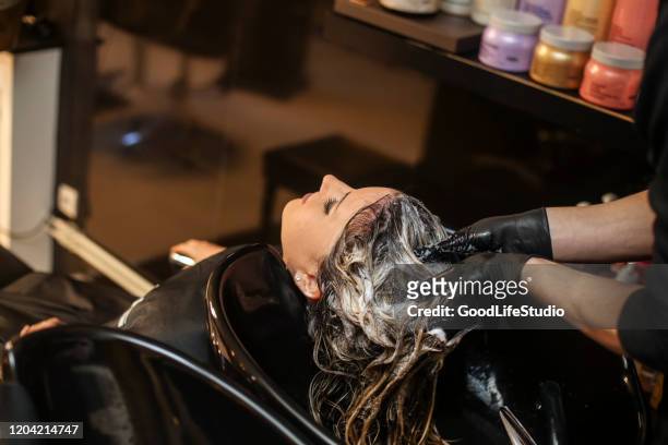 hair washing in a hair salon - hairdresser washing hair stock pictures, royalty-free photos & images