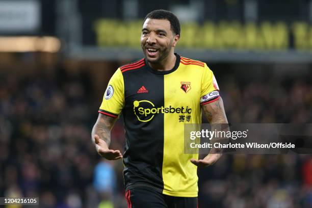 Troy Deeney of Watford celebrates their opening goal during the Premier League match between Watford FC and Liverpool FC at Vicarage Road on February...