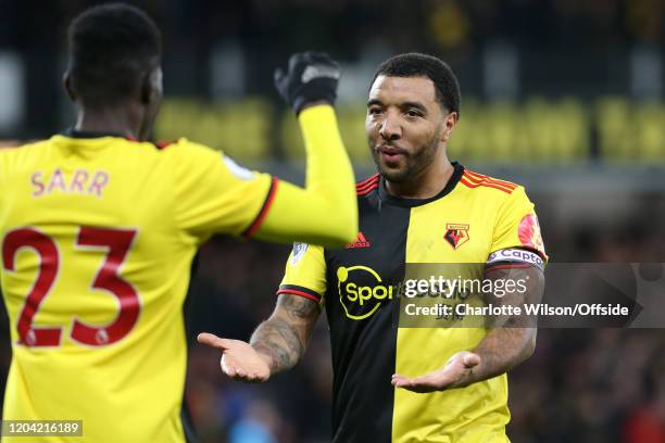 Troy Deeney of Watford celebrates their opening goal with goalscorer Ismaila Sarr during the Premier League match between Watford FC and Liverpool FC...