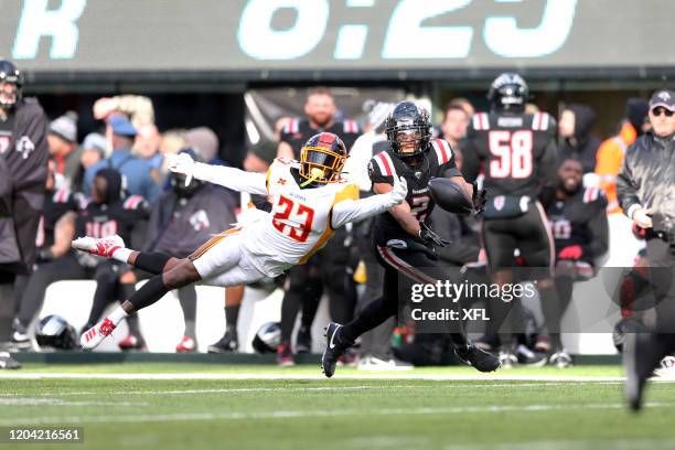 Mike Stevens of the LA Wildcats tries to break up the pass intended for Joe Horn of the New York Guardians during the XFL game at MetLife Stadium on...