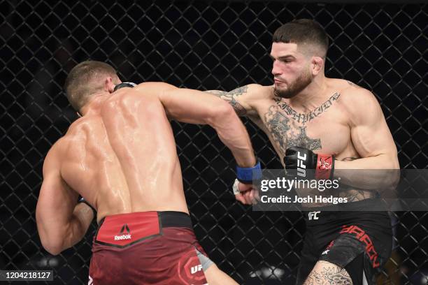 Sean Brady punches Ismail Naurdiev in their welterweight bout during the UFC Fight Night event at Chartway Arena on February 29, 2020 in Norfolk,...