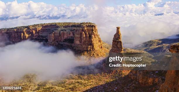 a cloud/fog inversion creeping into a valley in the colorado national monument (independence rock) in the grand valley of western colorado - fruita colorado stock pictures, royalty-free photos & images