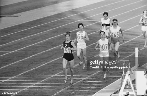 New Zealand athlete Marise Chamberlain crosses the finish line in first place ahead of Zsuzsa Szabo of Hungary, Ann Packer of Great Britain, Gerda...