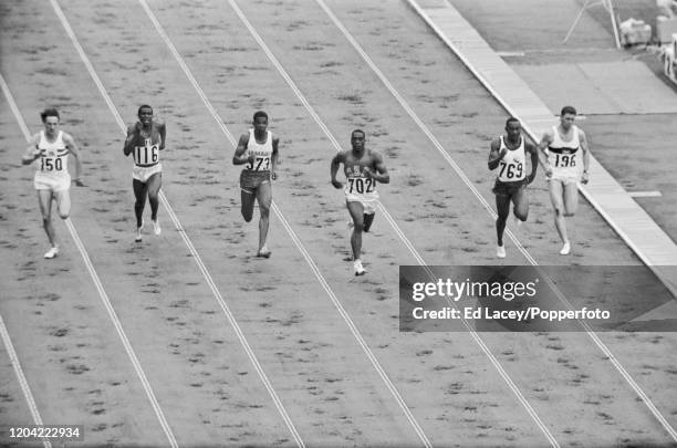 Bob Hayes of the United States leads Arquimedes Herrera of Venezuela, Lynn Headley of Jamaica and Heinz Schumann of Germany across the line to win...