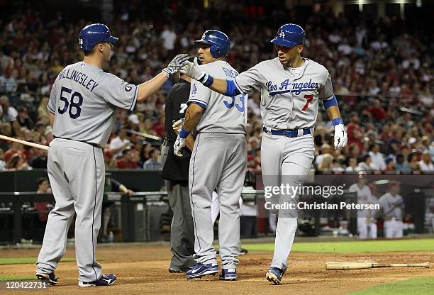 James Loney of the Los Angeles Dodgers high-fives teammates Chad Billingsley and Juan Rivera after scoring against the Arizona Diamondbacks during...