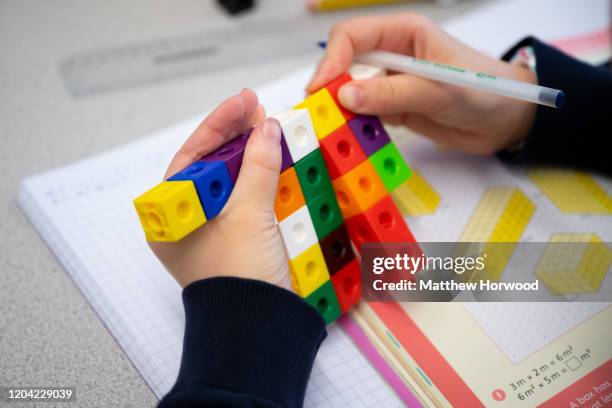 Primary school child studying maths using coloured cubes in a school on January 8, 2020 in Cardiff, United Kingdom.